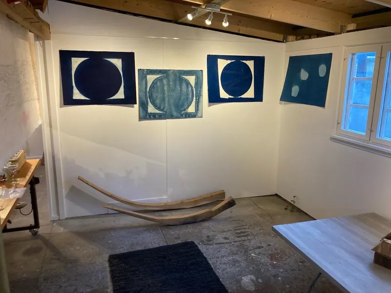 Gallery room hung with blue cyanotypes