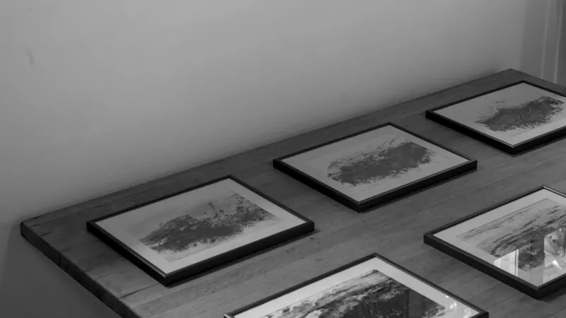 Framed prints laid out on a long table