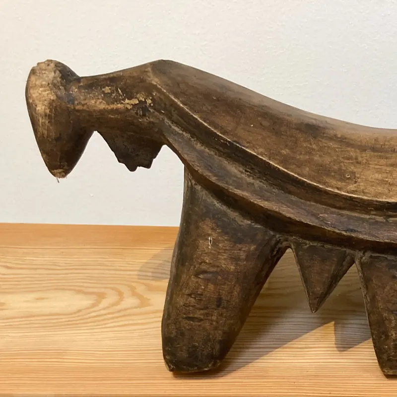 Carved wooden stool in the shape of an animal