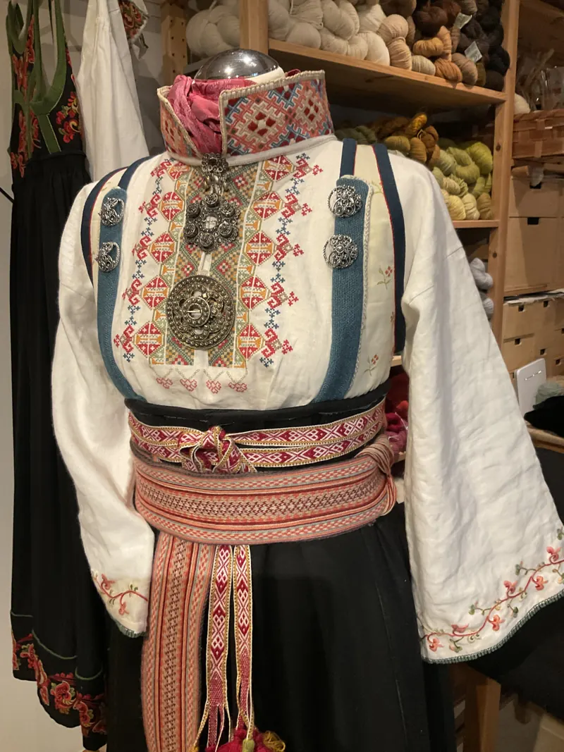 Embroidered Telemark costume with silver brooches and a woven red belt