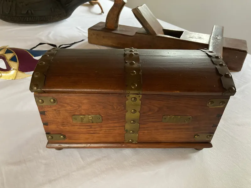 Antique wooden chest with brass corners and handles