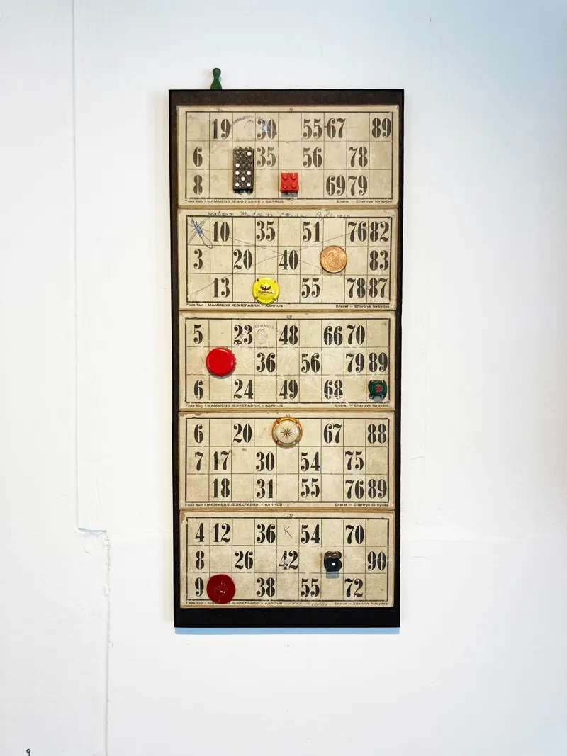 Bingo cards with red counters in a tall frame