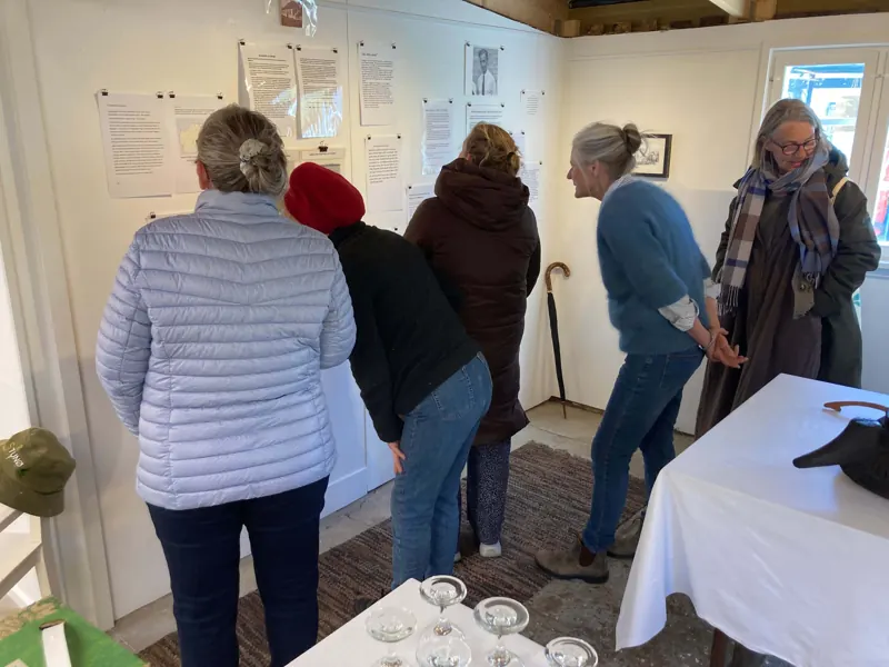 Visitors at the opening reading the stories on the walls